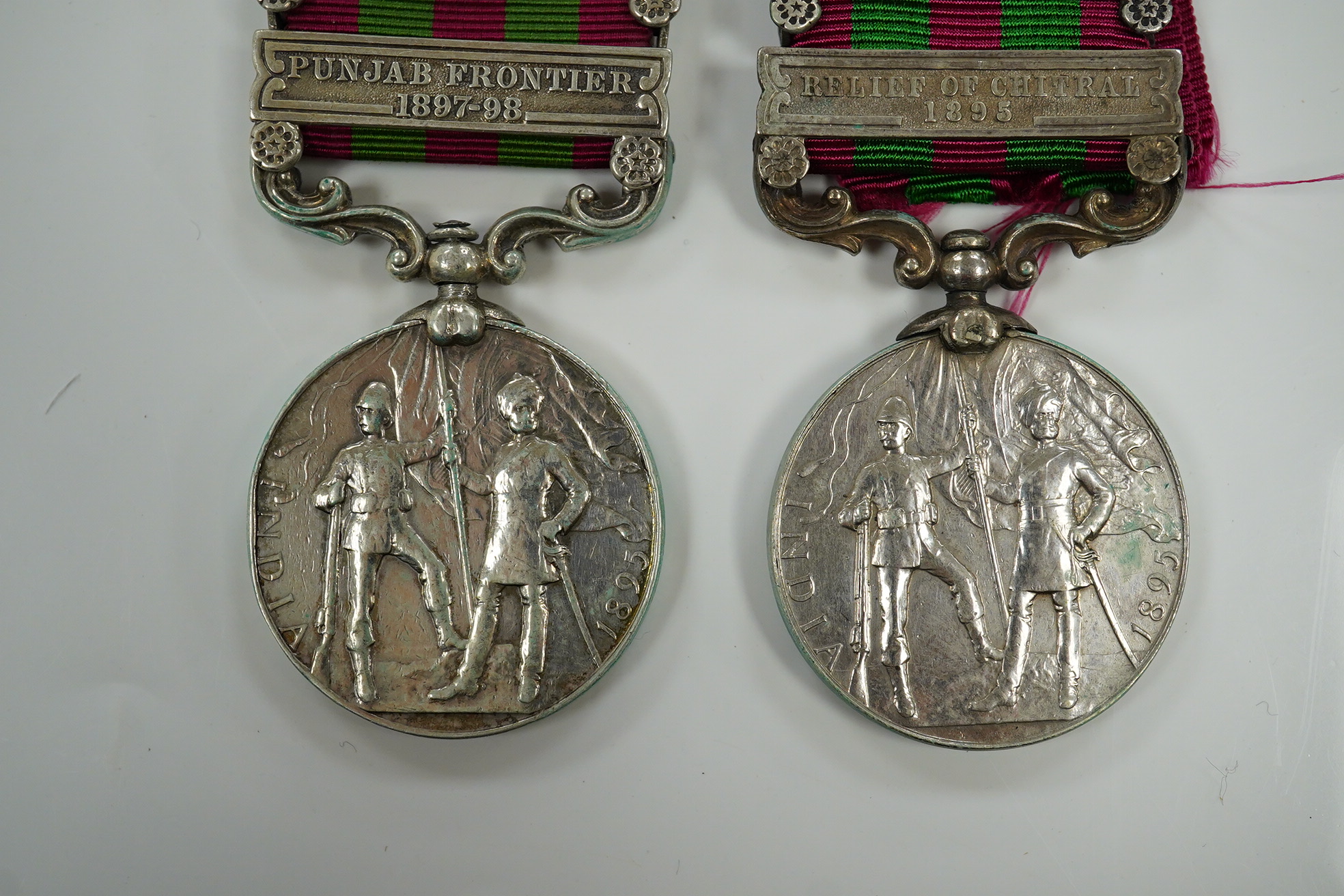 Two India Medals; one with Punjab Frontier 1897-98 and Relief of Chitral 1895 clasps, the other Tirah 1897-98 and Punjab Frontier 1897-98, both with naming erased.